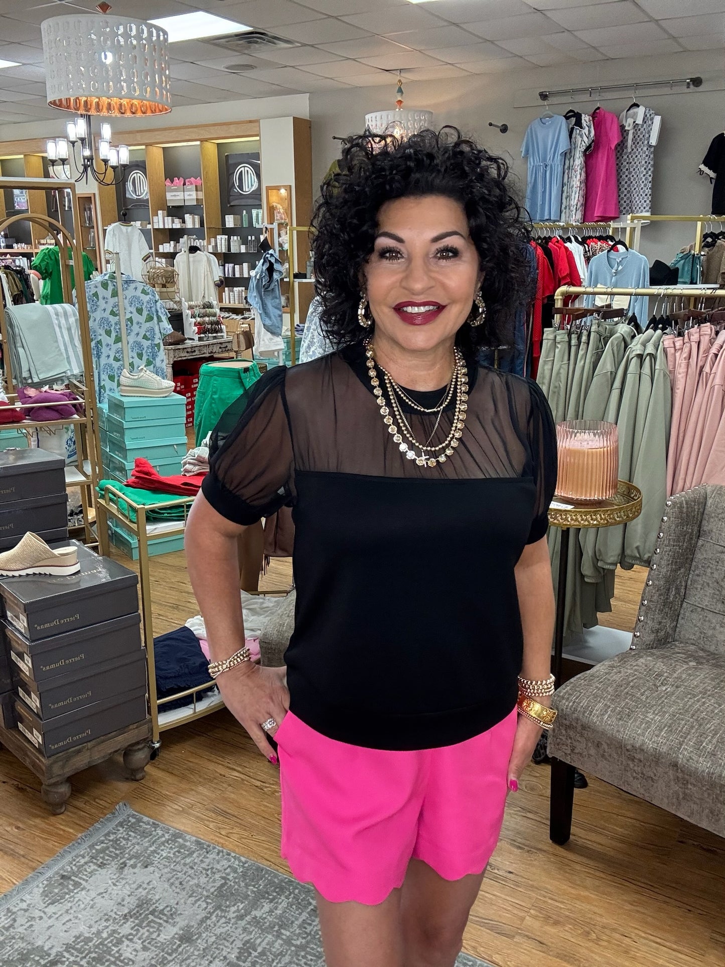 Solid top featuring sheer, puffed sleeves and a sheer yoke design. The bodice is made of opaque fabric