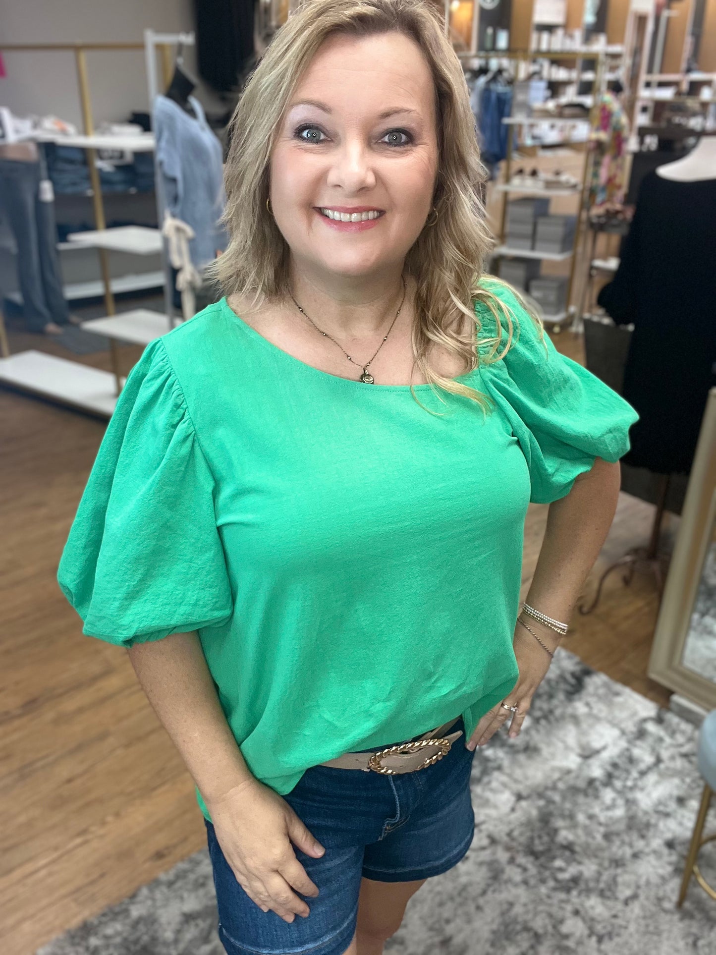 Solid top with asymmetry neck, and short balloon sleeves.