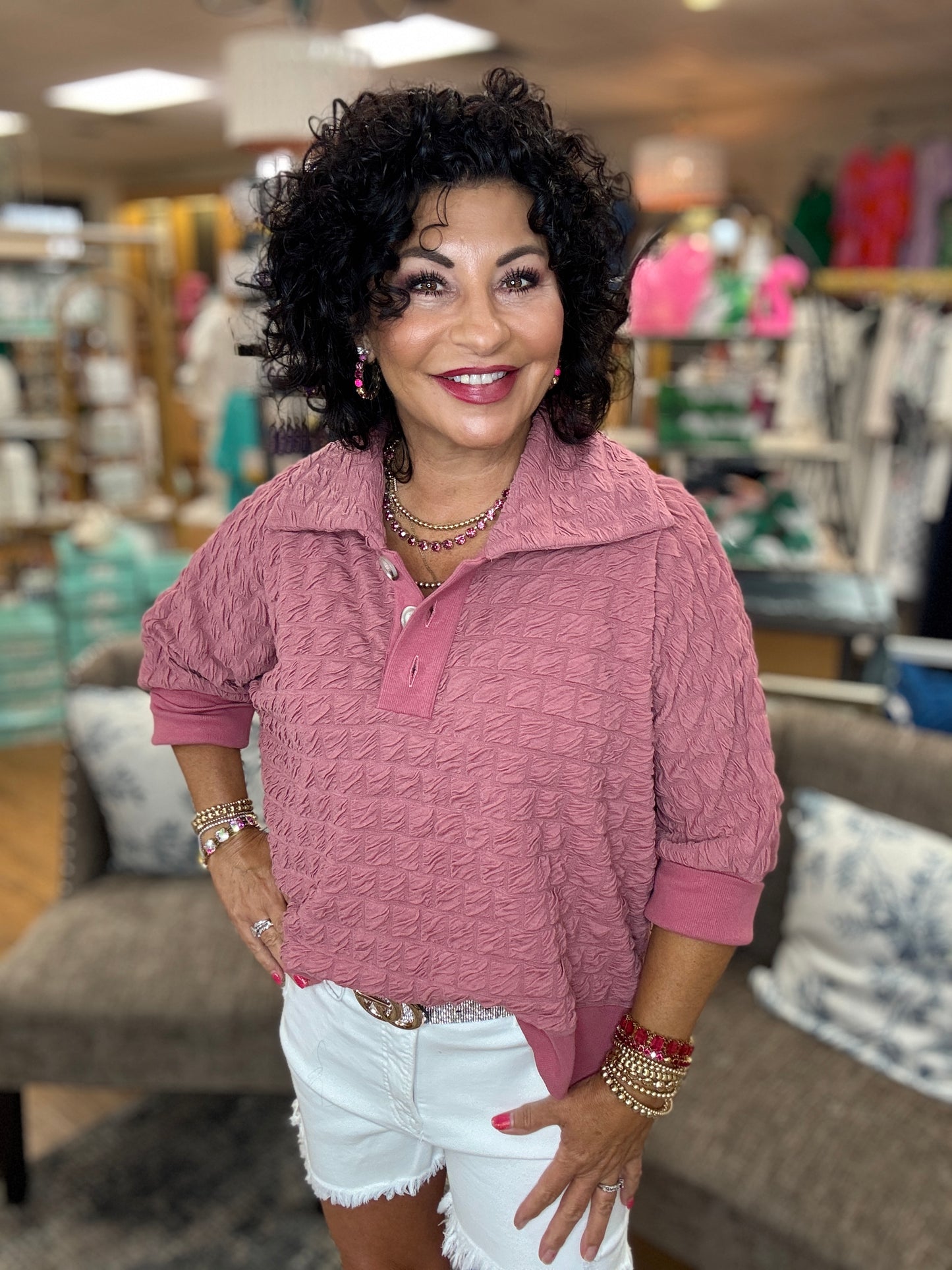 Textured pullover top with buttoned henley collared neck, three quarter kimono sleeves,