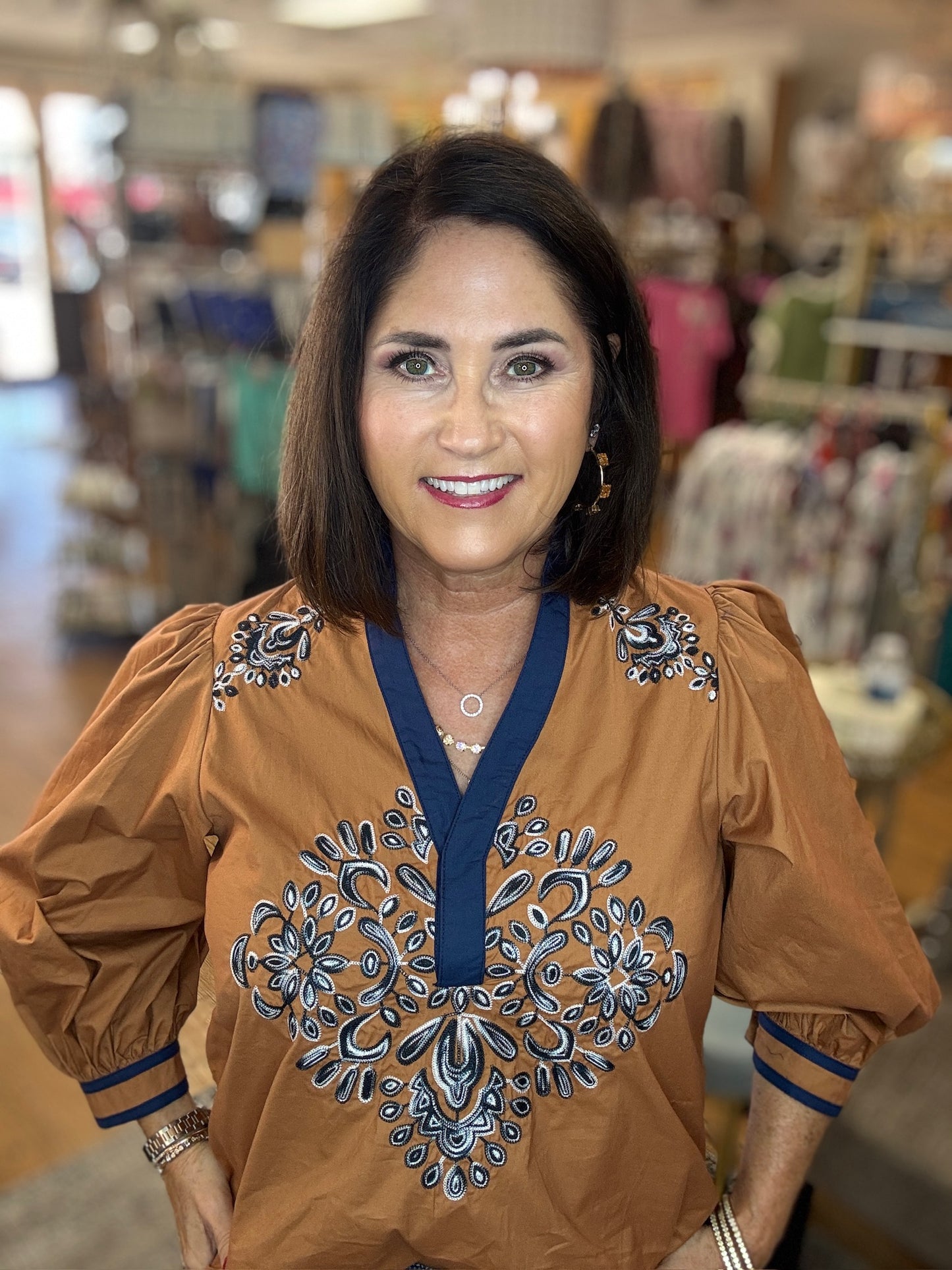 Solid 3/4 puff sleeve top featuring contrast trim split V-neck with ruffled stand collar