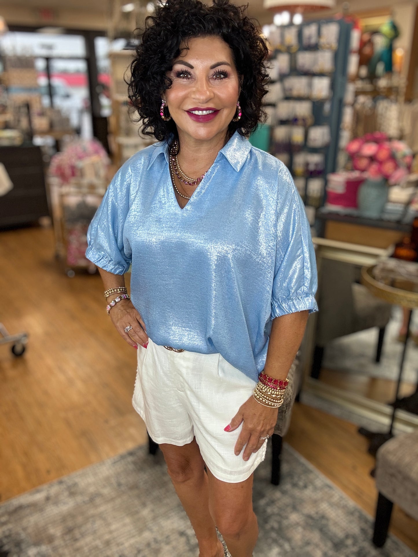 Metallic top with open collared neck, Half dolman sleeves, and stretch-band cuffs.