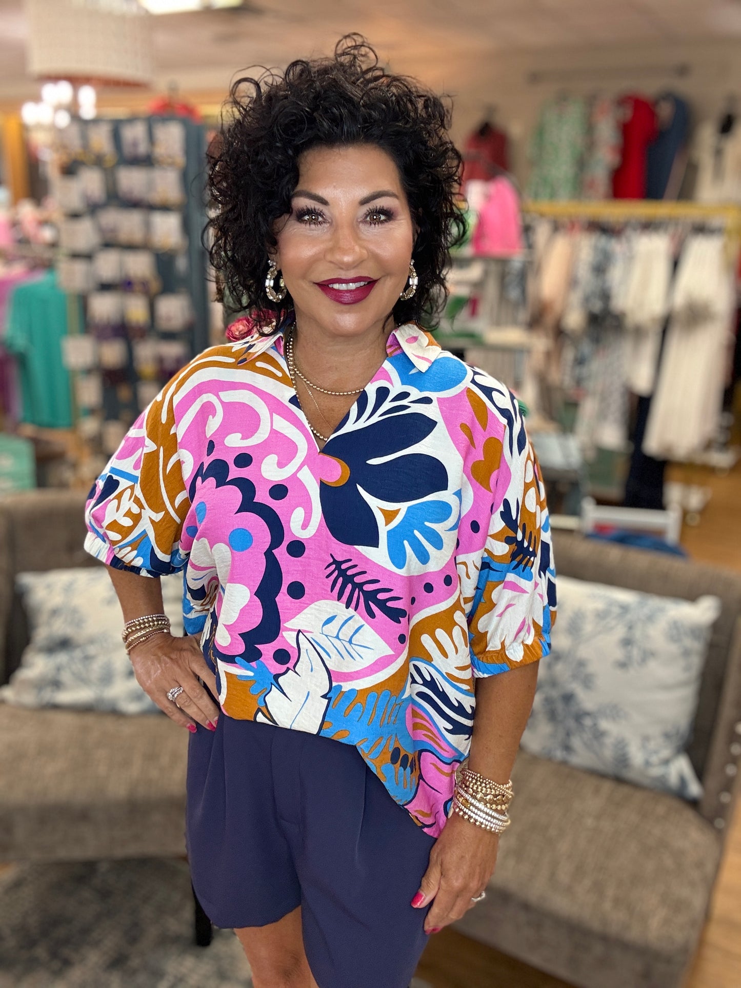 Multicolor print top with open collared neck, half dolman sleeves, and stretch-band cuffs
