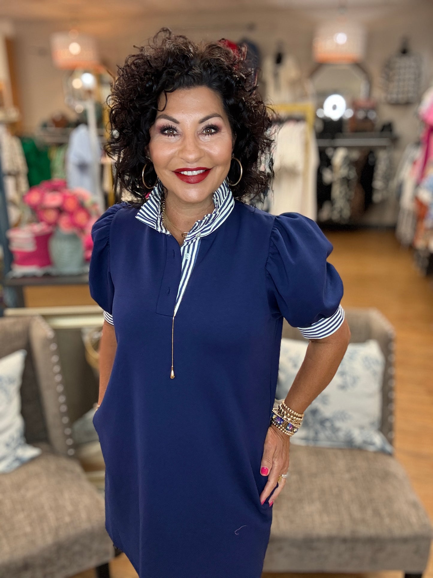 Solid short sleeve pullover polo dress featuring contrasting ruffle neck and sleeve band. Pockets at side