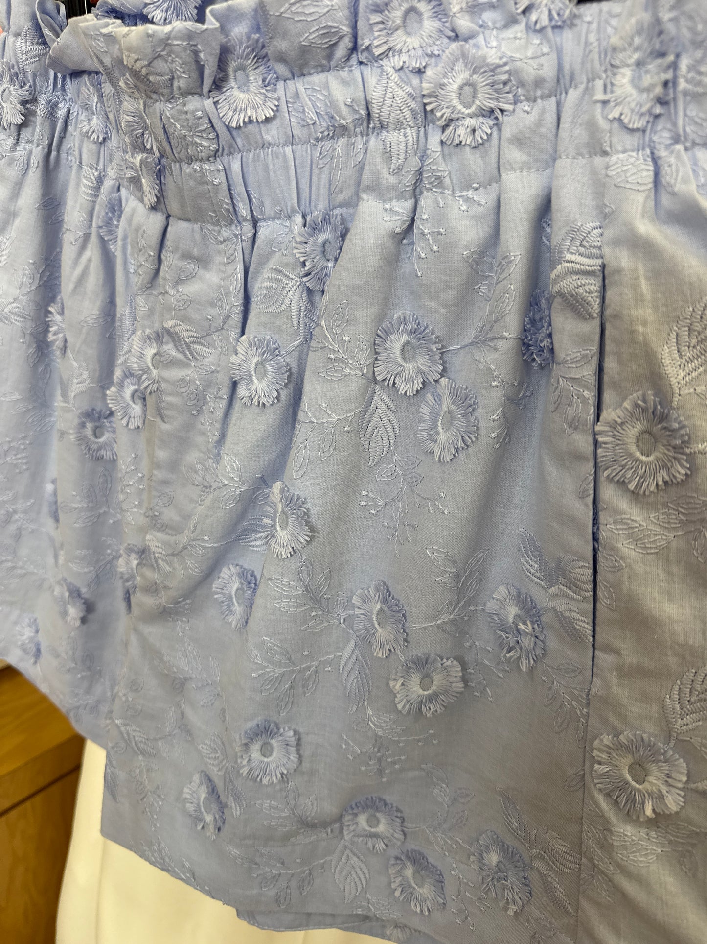 Solid embroidered floral applique high waisted shorts. Elastic waistband.