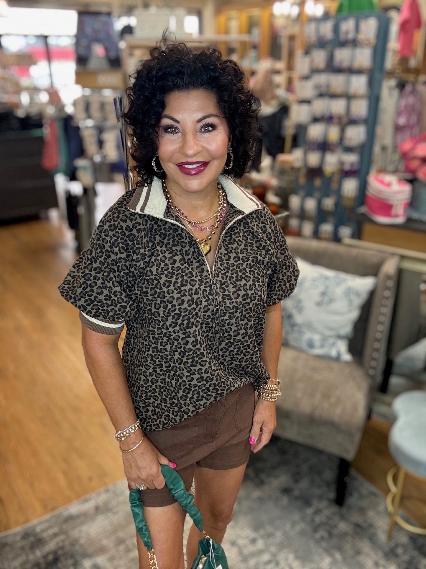 Leopard pattern short puff sleeve half-zip top featuring multicolor band collar.