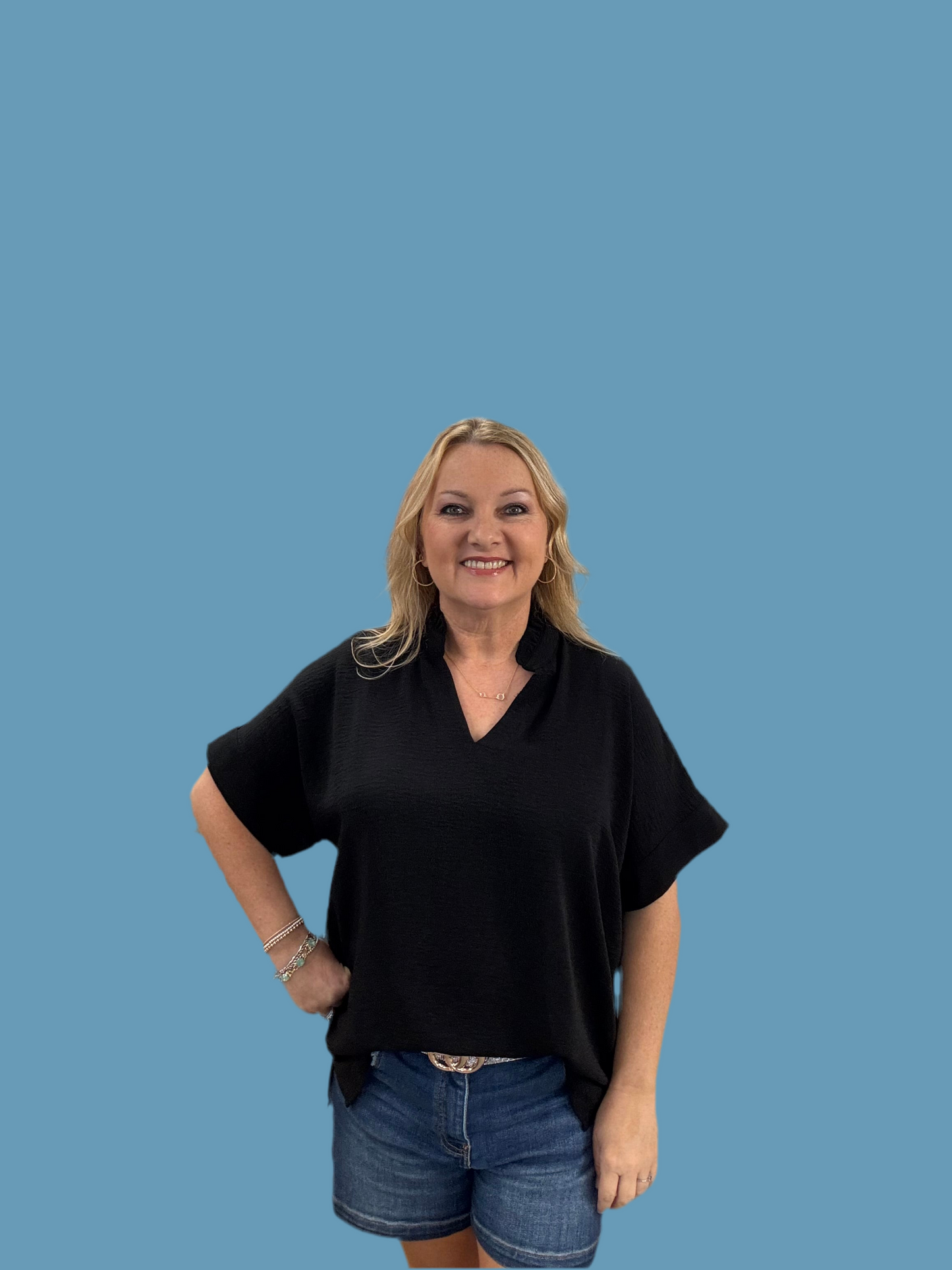 Solid top with frilled V-neck, short dolman sleeves, and band cuffs