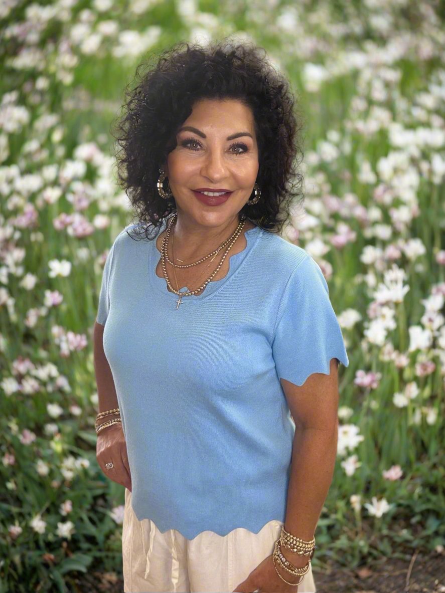 Solid knit top with scalloped edge detailing and short sleeves