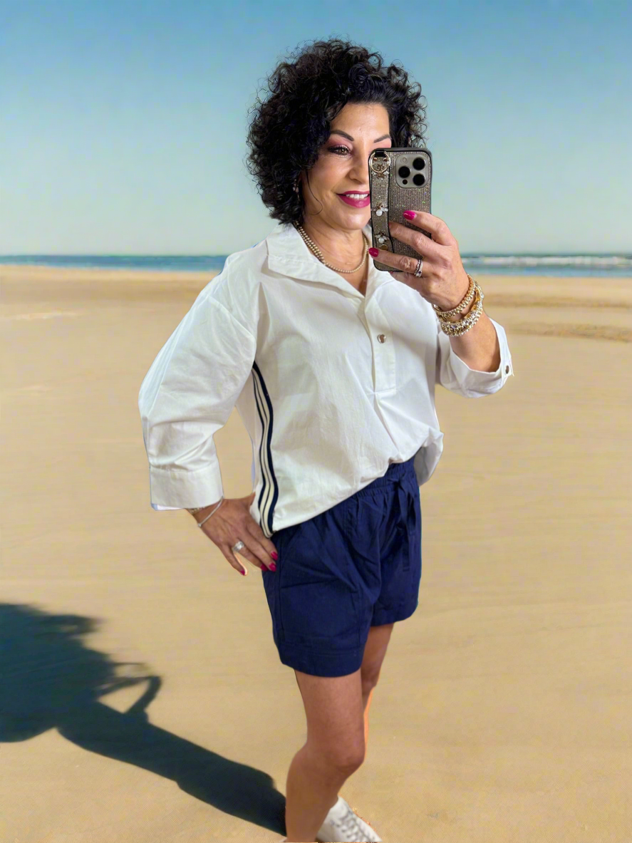 Solid single button closure spread collared pullover top featuring multicolor side band. Button closure cuff ¾ sleeves