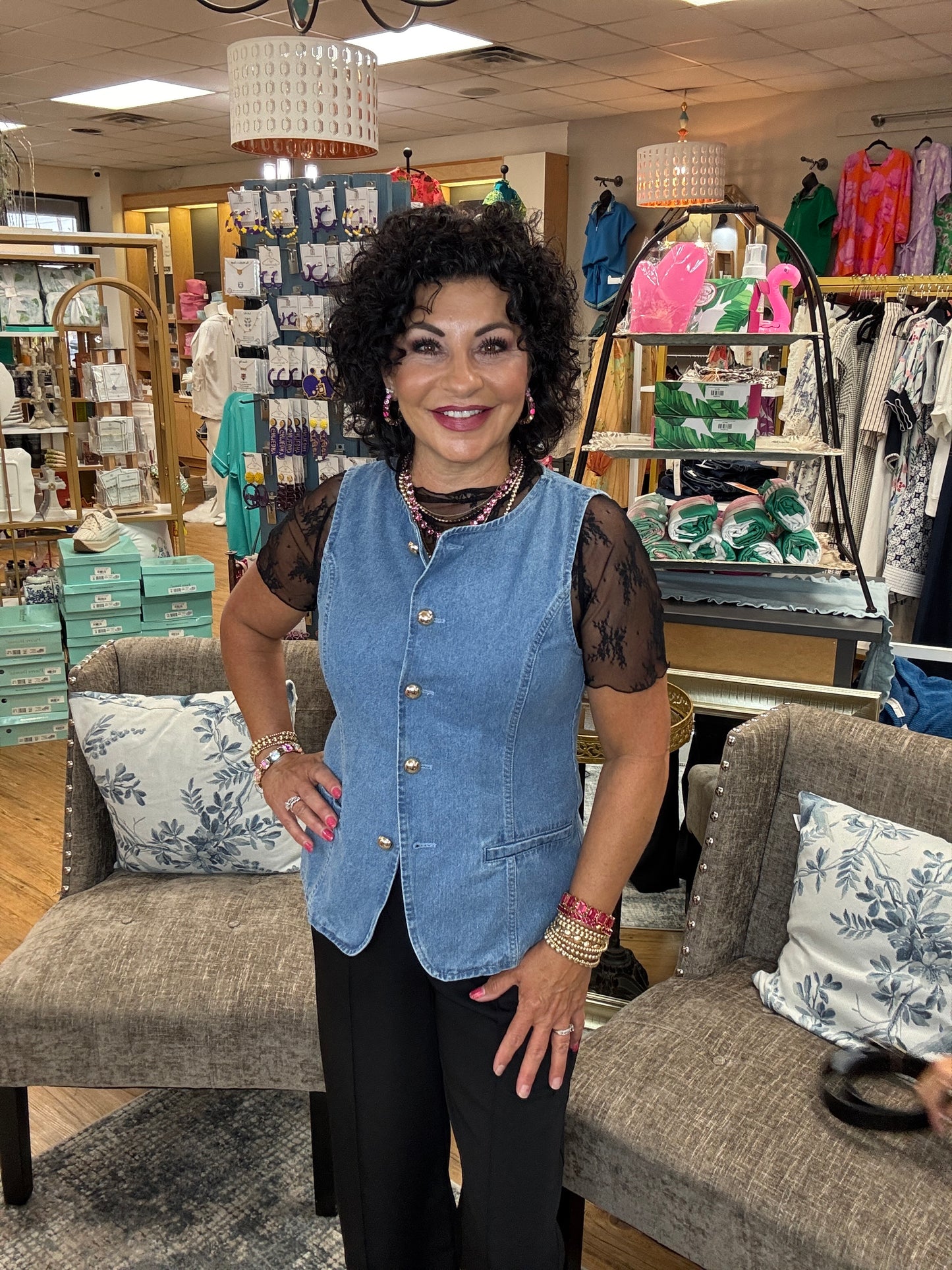 Solid sleeveless denim vest top featuring accented gold button at front