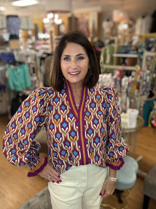 Geometric print long sleeve top featuring contrast trim split neck go