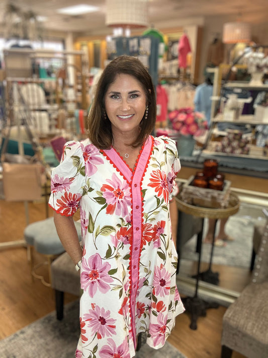 Floral print structured shoulder short sleeve mini dress featuring contrast accent scallop trim inset.