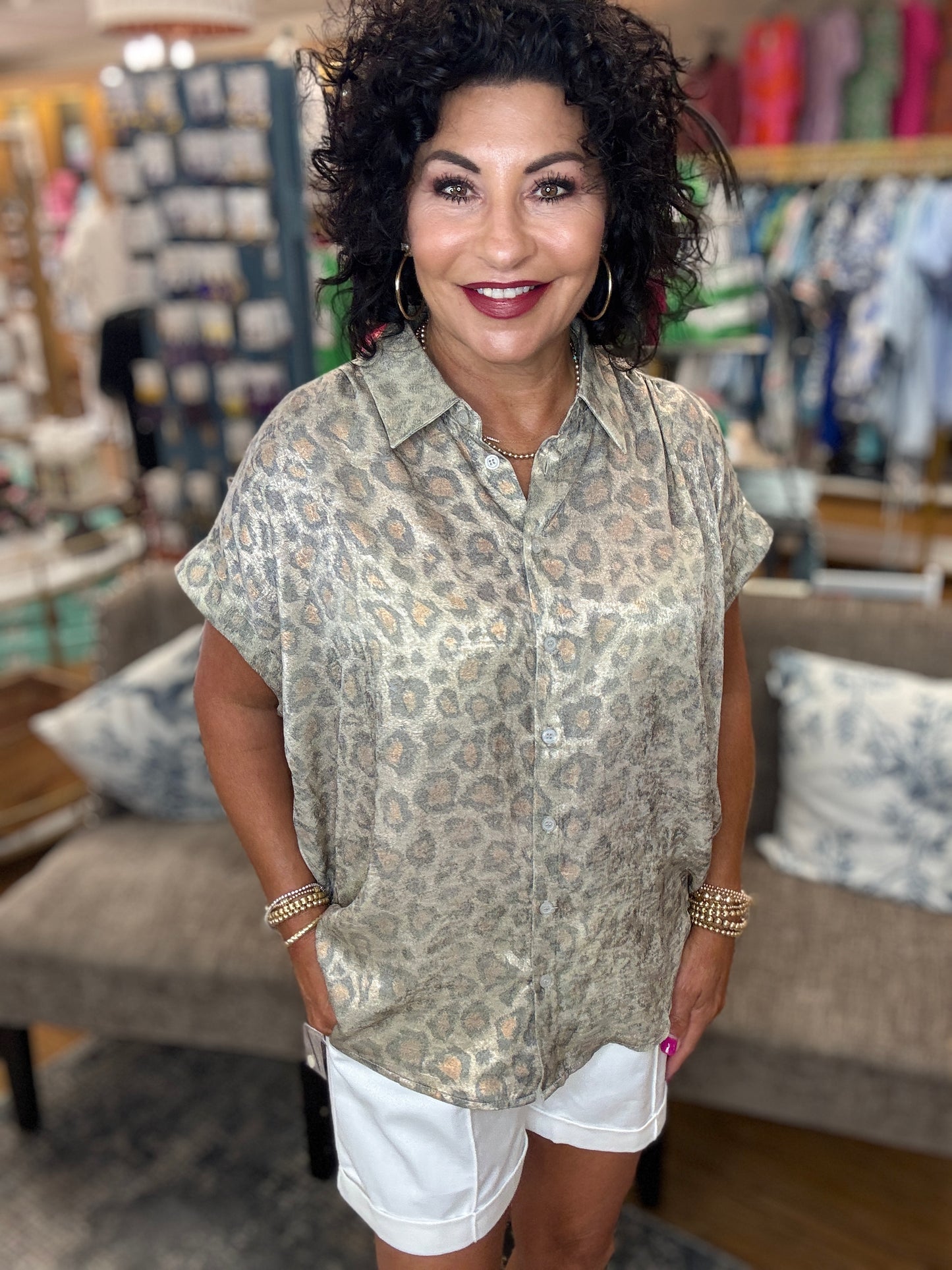 Leopard print collared button up top with cuffed short sleeves and ruched shoulders.