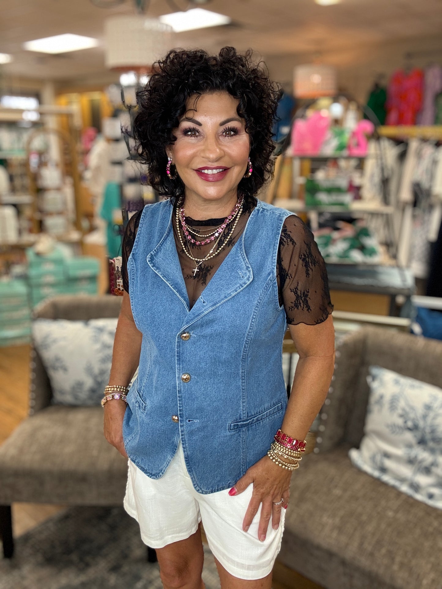 Solid sleeveless denim vest top featuring accented gold button at front