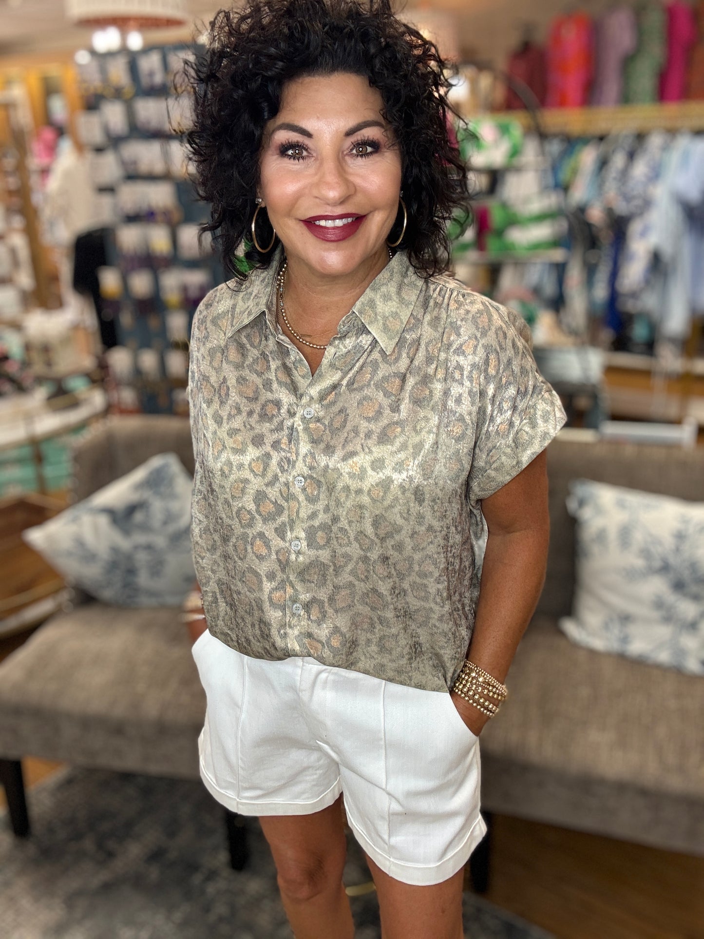 Leopard print collared button up top with cuffed short sleeves and ruched shoulders.