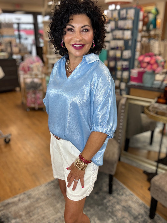 Metallic top with open collared neck, Half dolman sleeves, and stretch-band cuffs.