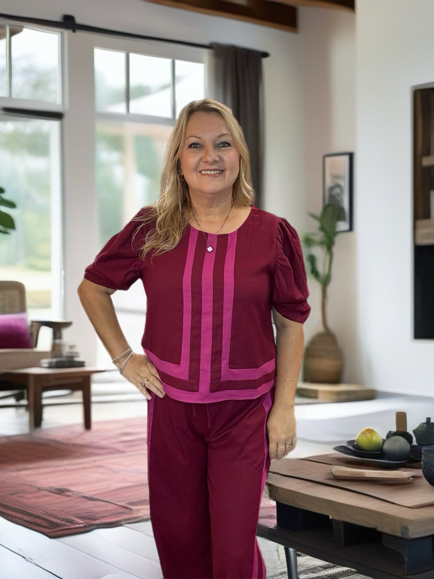 Solid high waist wide leg pull-on pants featuring contrast accented abstract border