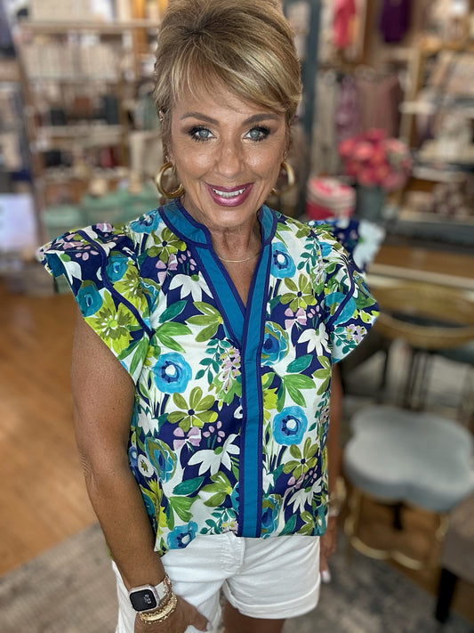 Multi-floral print flutter ruffle sleeve featuring contrast accent V-neck