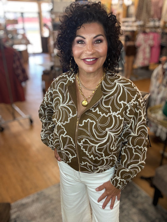 Textured long sleeve zip-up cropped jacket featuring floral embroidery
