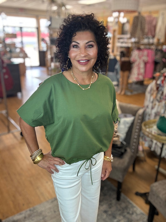 Solid short sleeve round neck top featuring adjustable drawstring hem