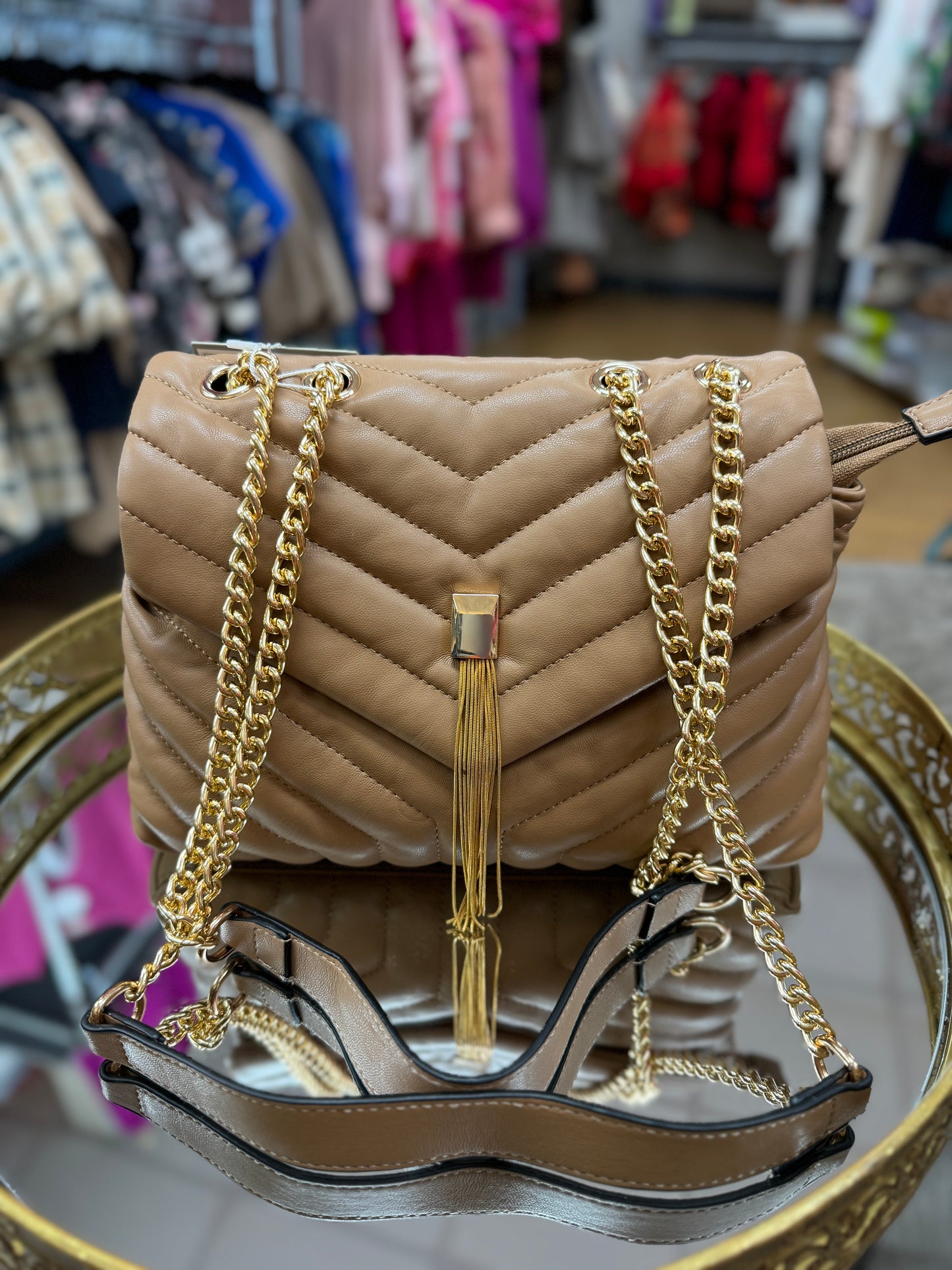 Tan quilted purse with gold embellishments