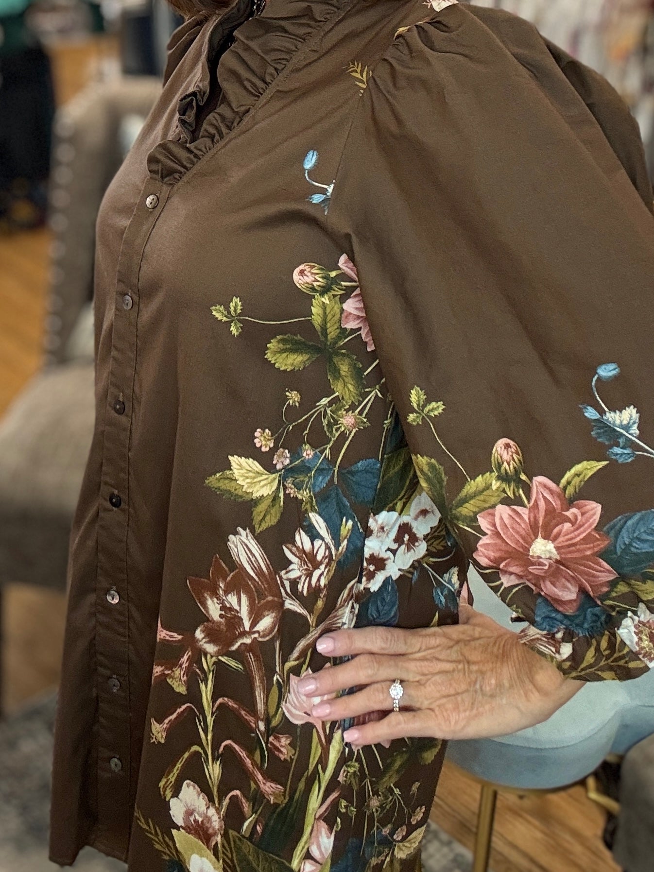 Botanical print 3/4 sleeve mini dress featuring ruffled accent V-neck.