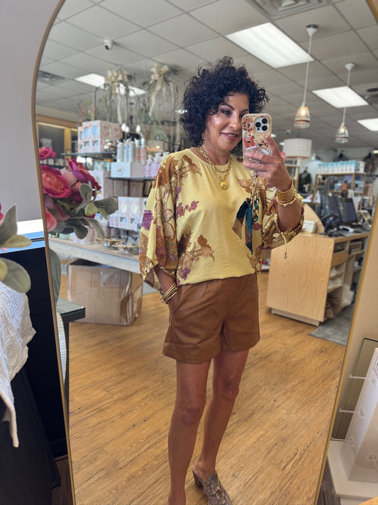 Botanical print ¾ sleeve puff top featuring textured fabric